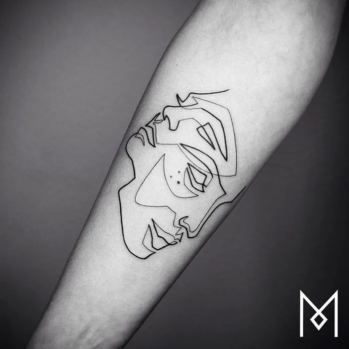 Minimalist single line tattoo on forearm, depicting an abstract face by Iranian-German artist.