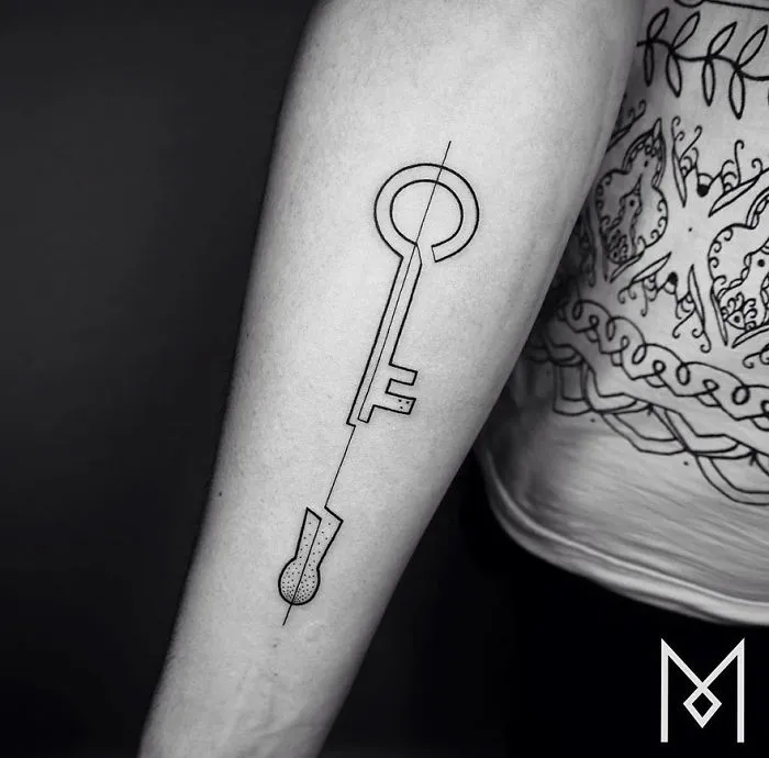 Minimalist single line tattoo of a key on a person's forearm, created by an Iranian-German artist.
