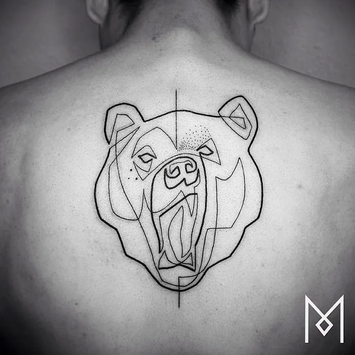 Minimalist single line tattoo of a bear's head on a person's back, featuring geometric patterns.