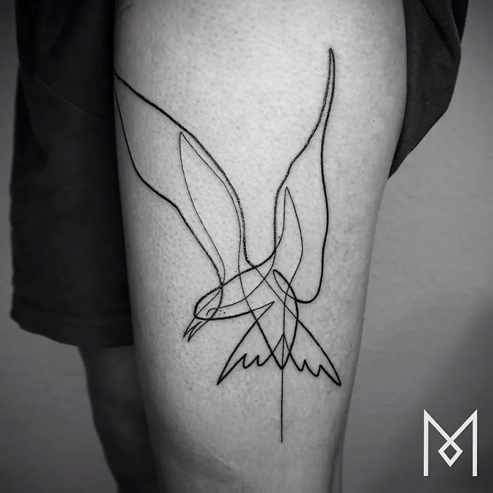 Minimalist single line tattoo of a bird on a person's leg, by Iranian-German artist.