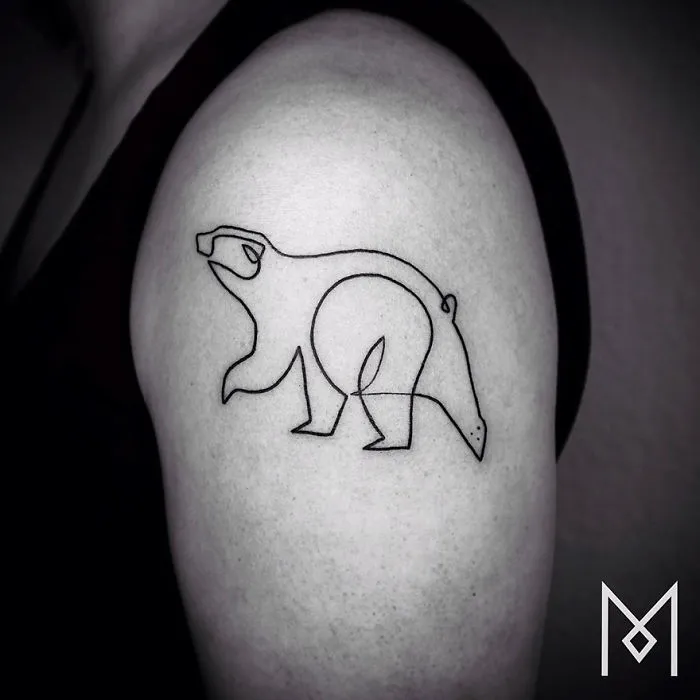 Minimalist single line tattoo of a bear on upper arm by Iranian-German artist.
