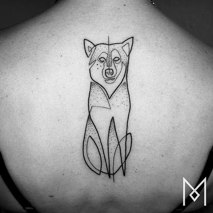 Minimalist single line tattoo of a dog on a person's back, designed by Iranian-German artist.