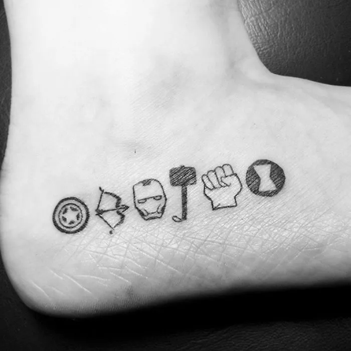 Minimalist Avengers-themed small foot tattoos showcasing less is more.