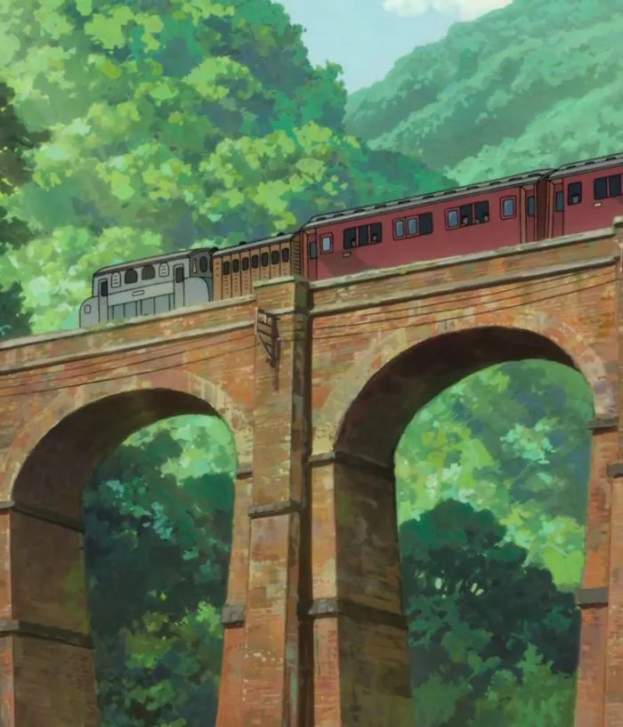 Train on a bridge surrounded by lush greenery in a Studio Ghibli style illustration.