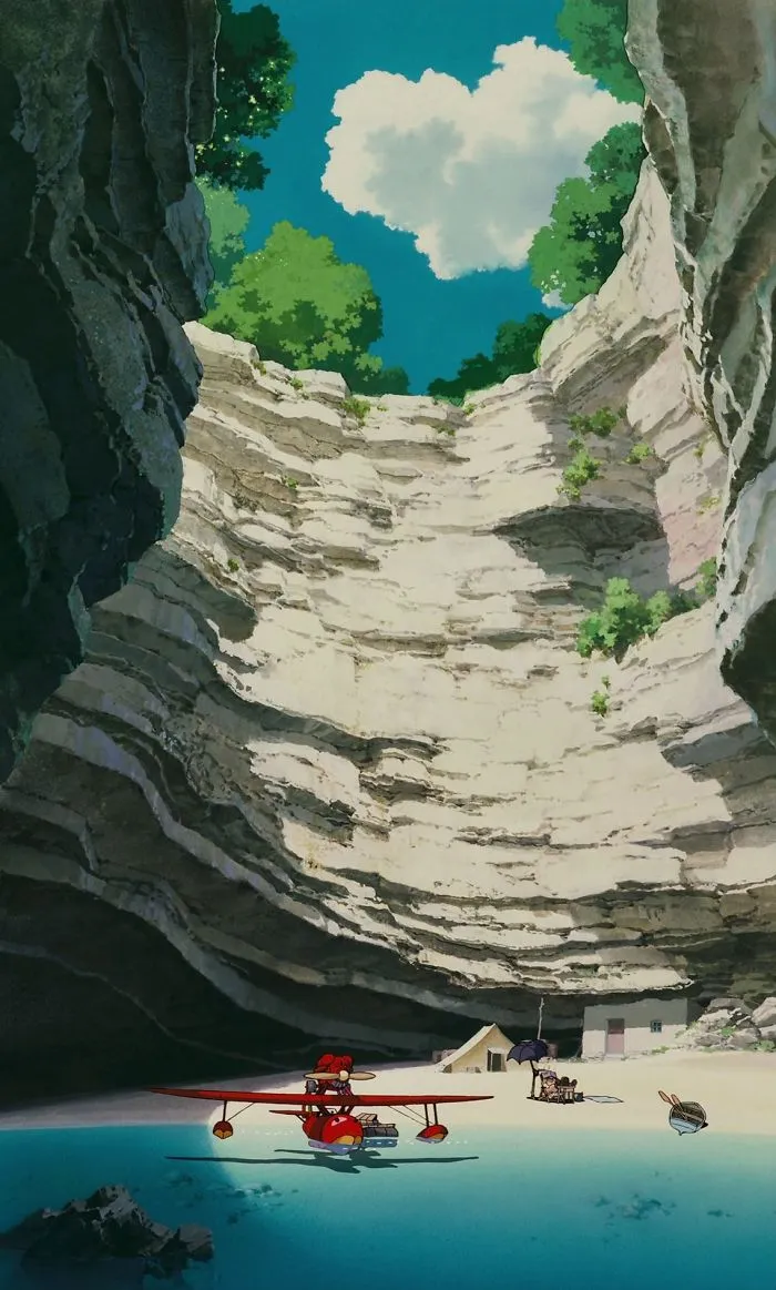 Studio Ghibli wallpaper featuring a red seaplane in a serene, rocky cove scene.