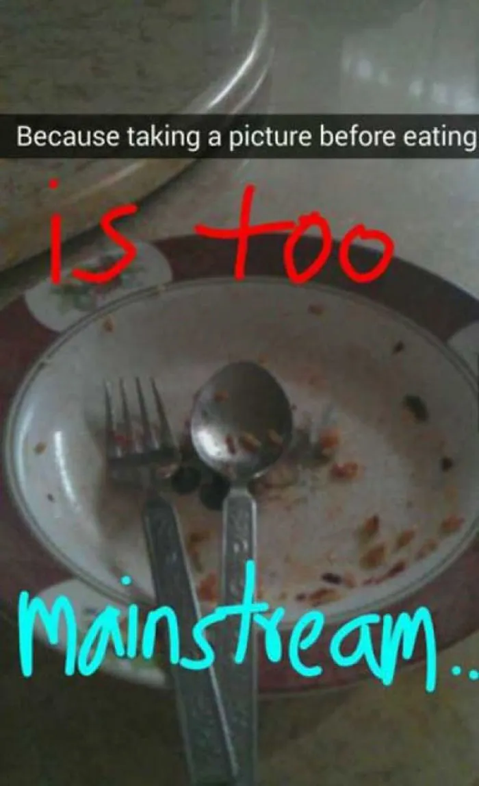 Empty plate with fork and spoon, text overlay reads "Because taking a picture before eating is too mainstream," humorous Snapchat.