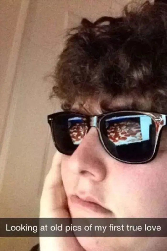 Person wearing sunglasses with a pizza reflection, captioned humor about looking at old photos of love.