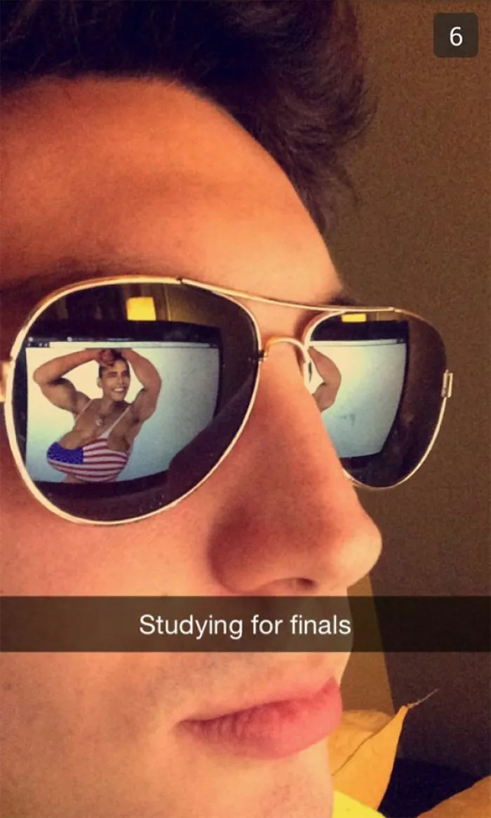 Man wearing sunglasses reflects a bodybuilder, captioned "Studying for finals." Funny Snapchat humor.