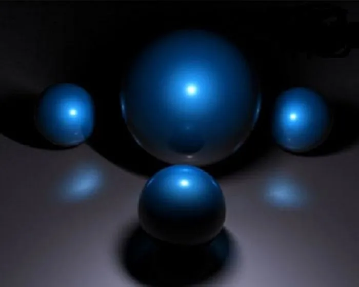 Blue spherical objects on a dark background, representing Studio Ghibli's 31st birthday theme for smartphone wallpapers.