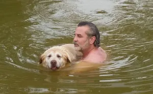 This Dog Is Too Old To Swim, So Her Owner Became Her Flotation Device