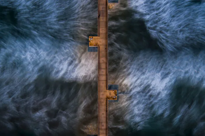 Moving Water Under The Venice Pier