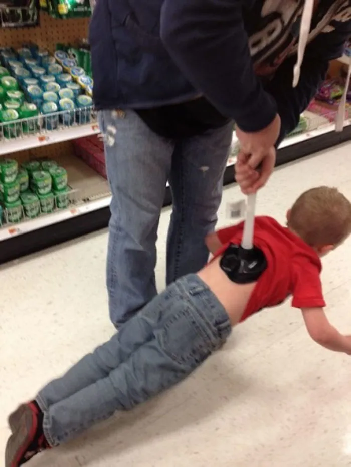 Dad using a plunger to lift a child in a store aisle