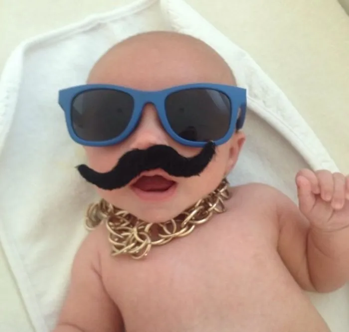 Baby wearing sunglasses, fake mustache, and gold chain for kids can't be left alone with dads