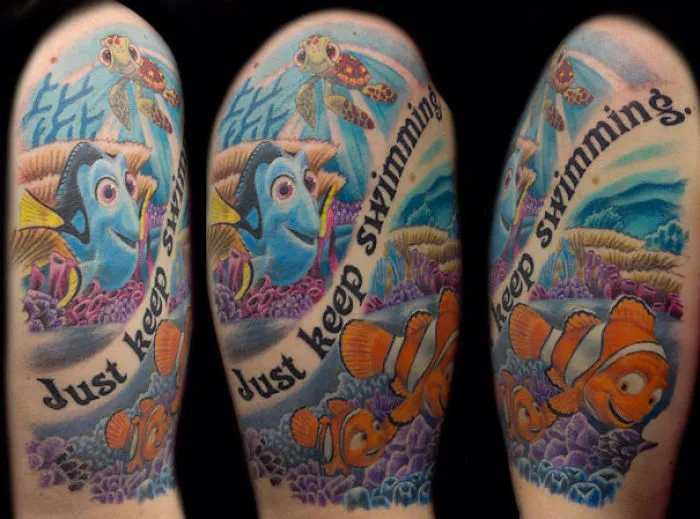 Pixar tattoo featuring colorful fish and coral with the phrase "Just keep swimming."