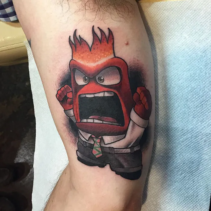 Pixar-inspired tattoo of an animated character expressing anger on a person’s arm.