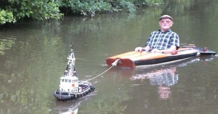 Man Spotted Using Tiny Tug Boat To Effortlessly Cruise Down The River