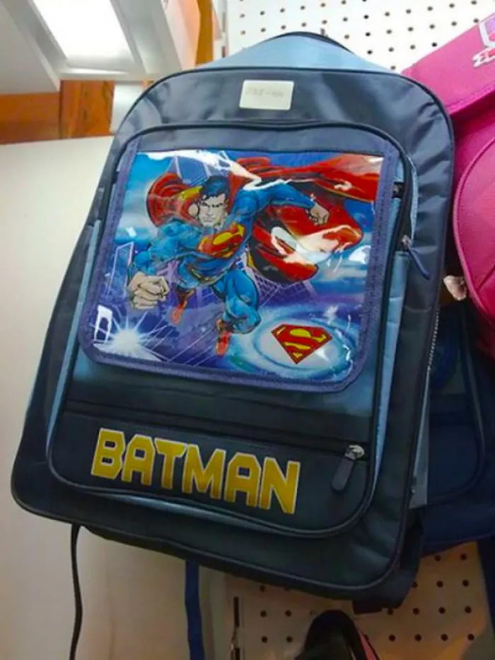 Backpack with Superman image labeled as Batman, illustrating job fail.