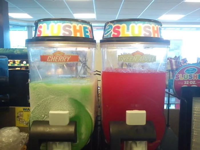 Slushie dispensers mislabeled; cherry shows green, green apple shows red, illustrating a humorous job fail.