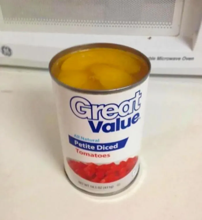 Can labeled as diced tomatoes filled with peach slices, illustrating a job fail.