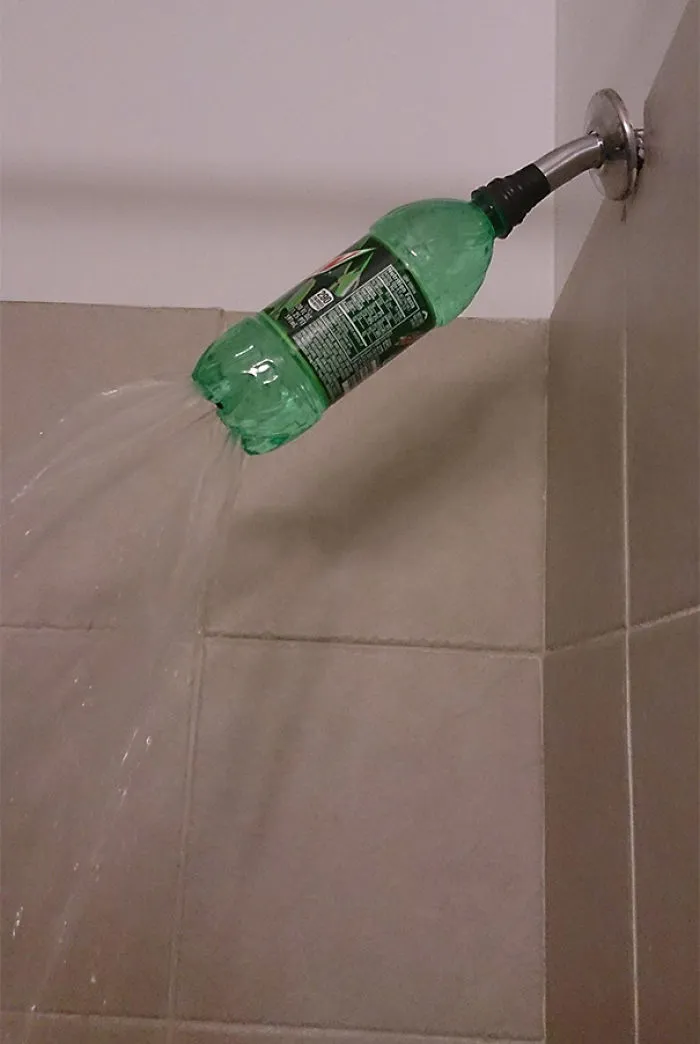 Plastic bottle used as a showerhead, demonstrating a DIY fail.