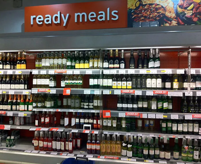 Supermarket display mislabeled as "ready meals," showing shelves of alcohol.