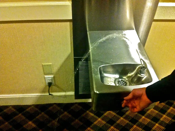 Drinking fountain fail with water spraying sideways instead of into the basin.