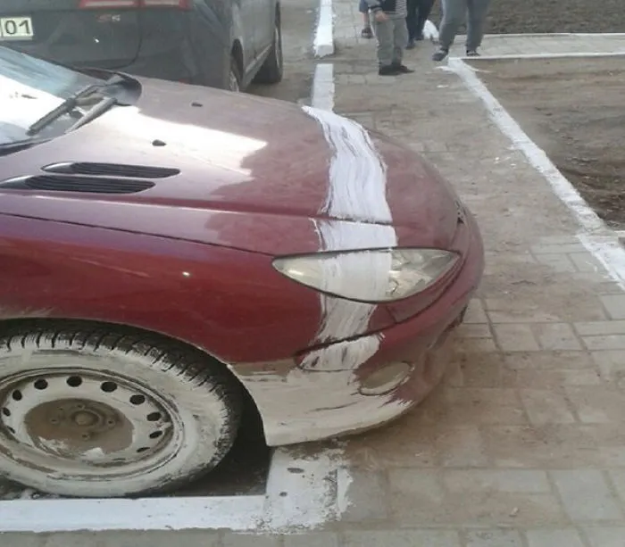 Car with a paint stripe across it, showcasing a failed job attempt.
