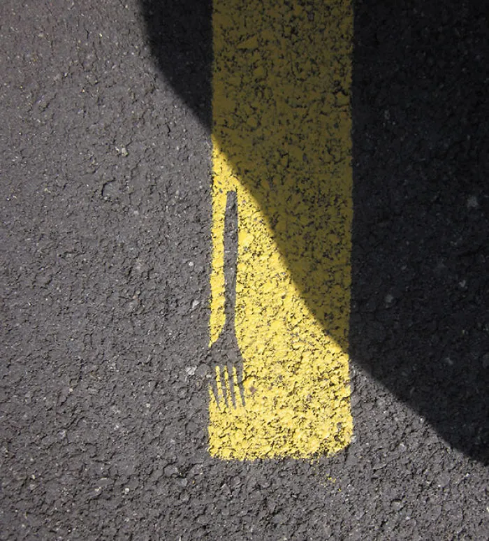 Fork shadow misaligned with yellow road line, illustrating a failed job attempt.