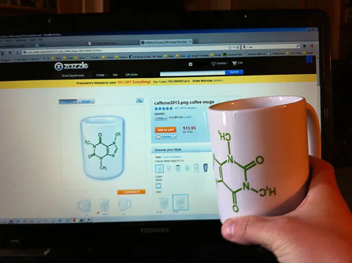 Coffee mug with chemical formula held in front of online shop listing, showing a job fail in design.