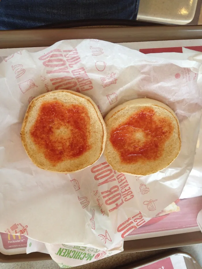 Burger buns with poorly placed ketchup, illustrating a humorous work fail.