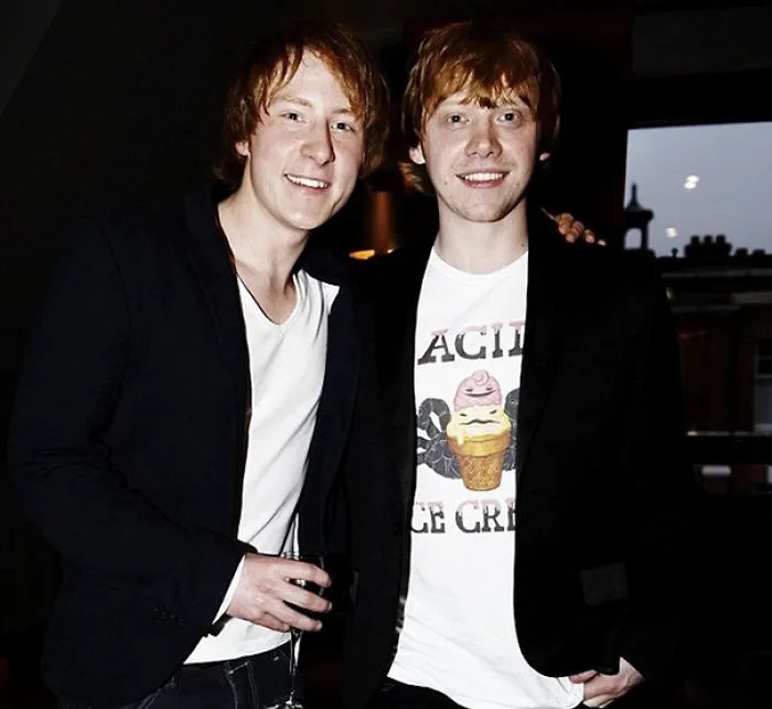 Two red-haired men smiling together indoors, illustrating Hollywood body doubles and celebrity lookalikes.