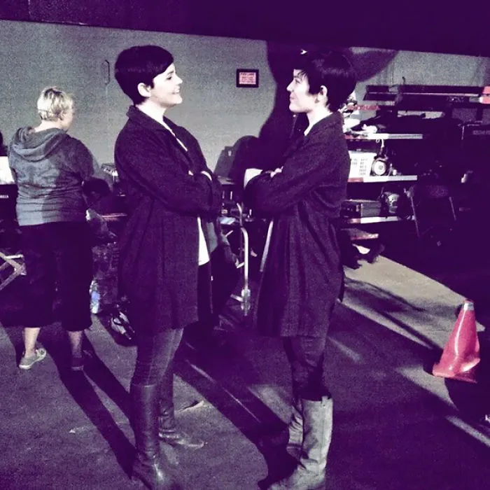 Two women dressed alike standing face to face on a film set, illustrating Hollywood celebrities’ body doubles.