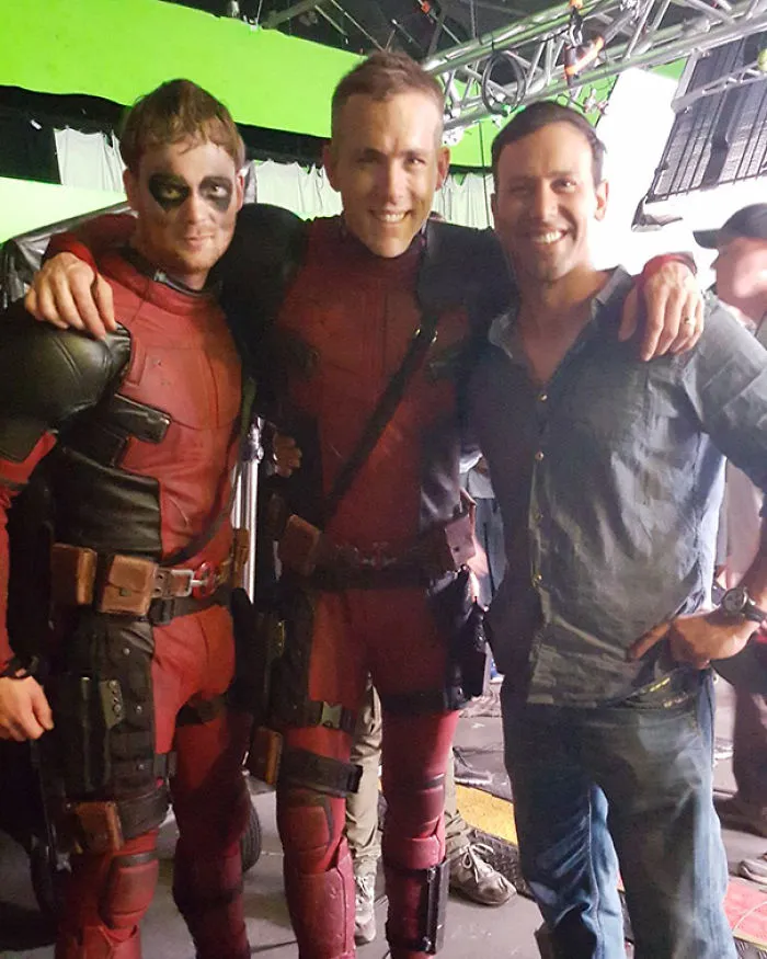 Three men on a film set with two wearing red superhero costumes, illustrating Hollywood celebrity body doubles.