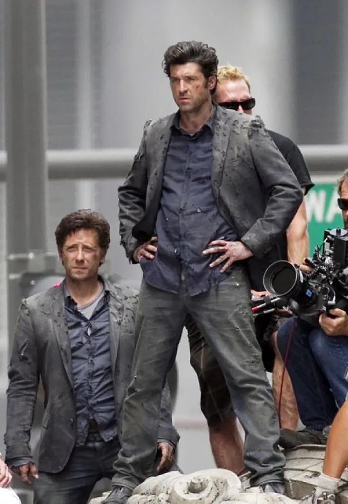 Actor and body double dressed in matching costumes on a film set demonstrating Hollywood celebrity body doubles.