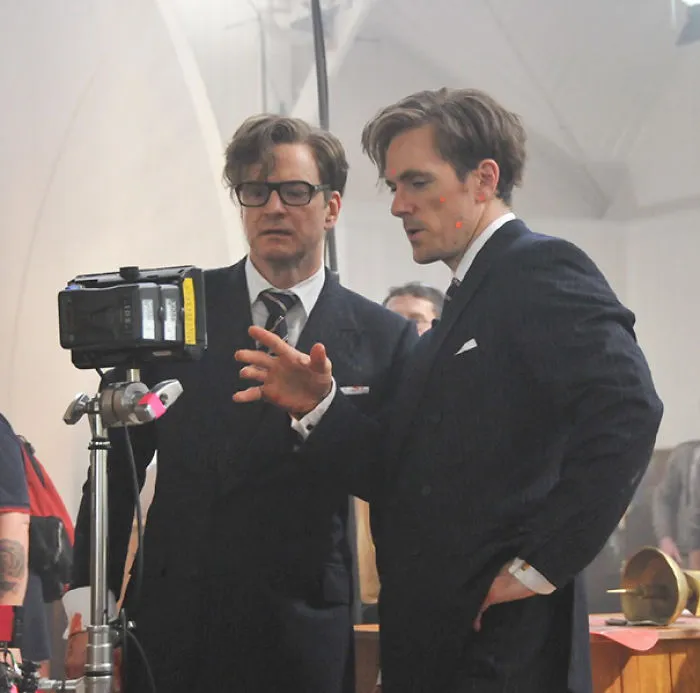 Two men in suits reviewing footage on a camera monitor, illustrating Hollywood celebrities body doubles on set.