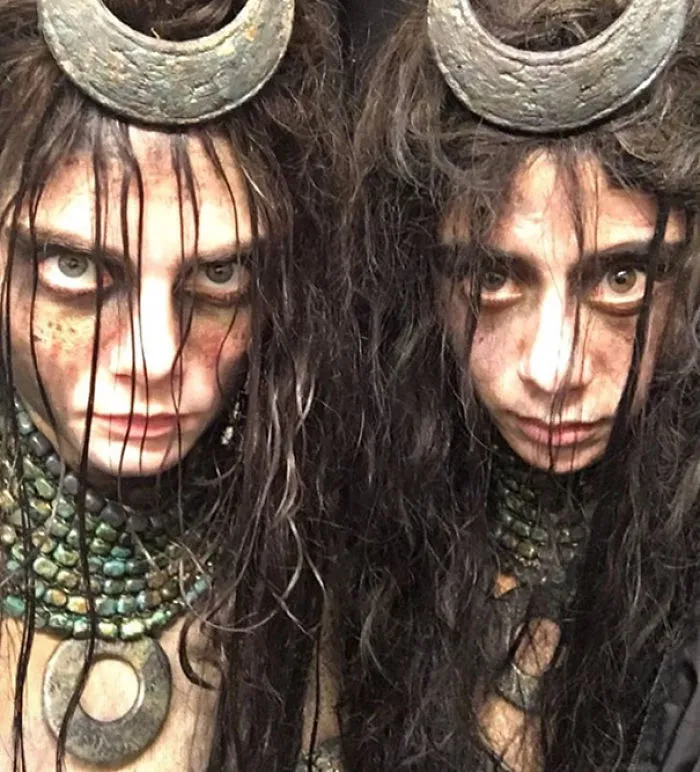 Two women with tribal makeup and costumes, showcasing Hollywood celebrities’ body doubles in a dramatic look.