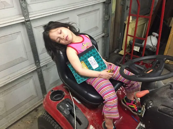 Napping On The Riding Lawn Mover. Amazing That She Can Still Hold On To Her Book And Crayons