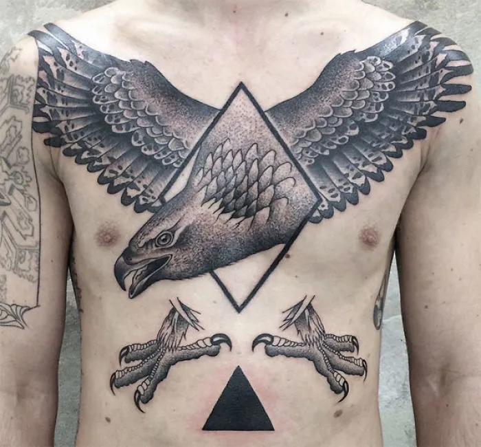 Symmetrical tattoo by Valentin Hirsch featuring an eagle blending nature and geometry on a person's chest.