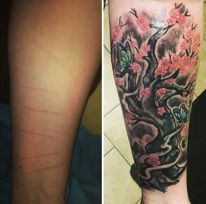 Floral scar-covering tattoo on arm, featuring pink blossoms and green butterflies.