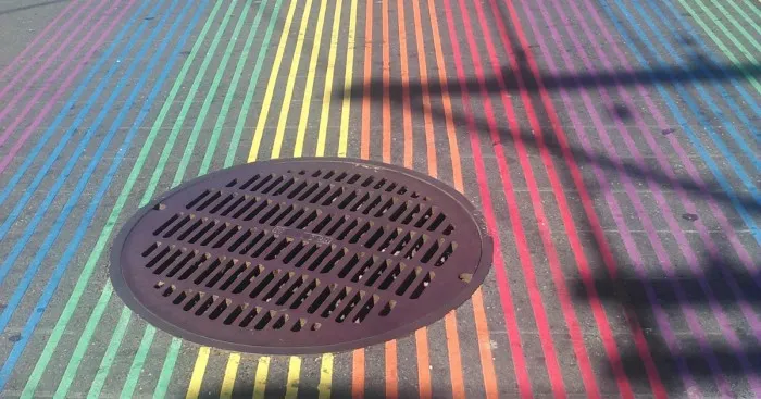 Floating Manhole Cover In The Rainbow Crosswalk Of San Francisco
