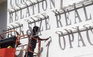 Typographic Shadow Graffiti Turns Boring Building Into Ever Changing Masterpiece