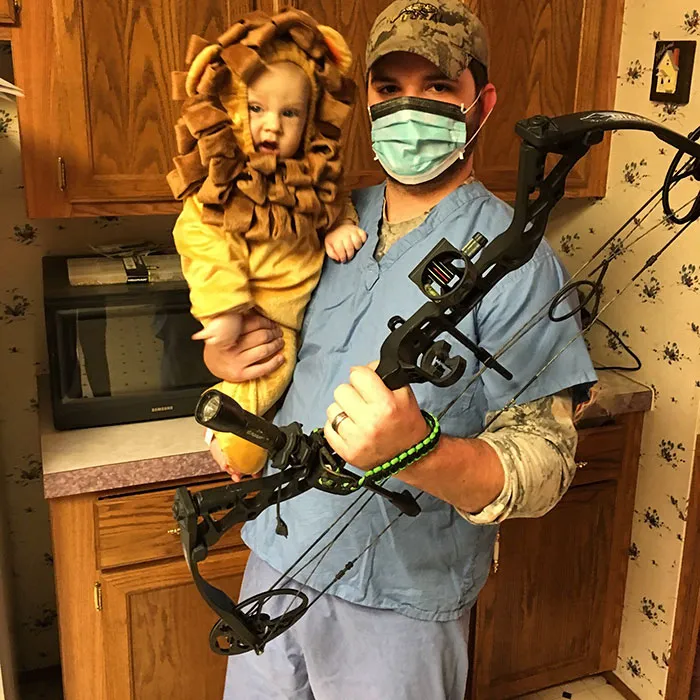 Father holding a baby in a lion suit as creative Halloween costume ideas