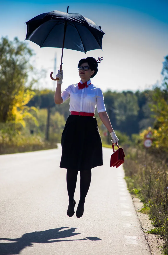 Woman floating in air with umbrella as a creative Halloween costume idea