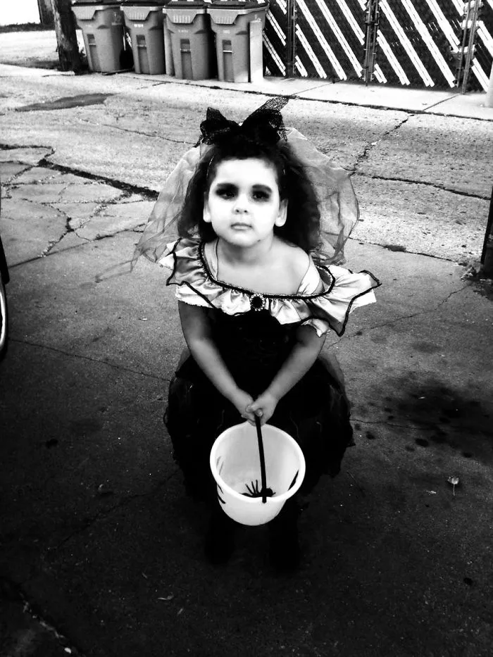 Black and white photo of a child dressed as a spooky bride for creative Halloween costume ideas.