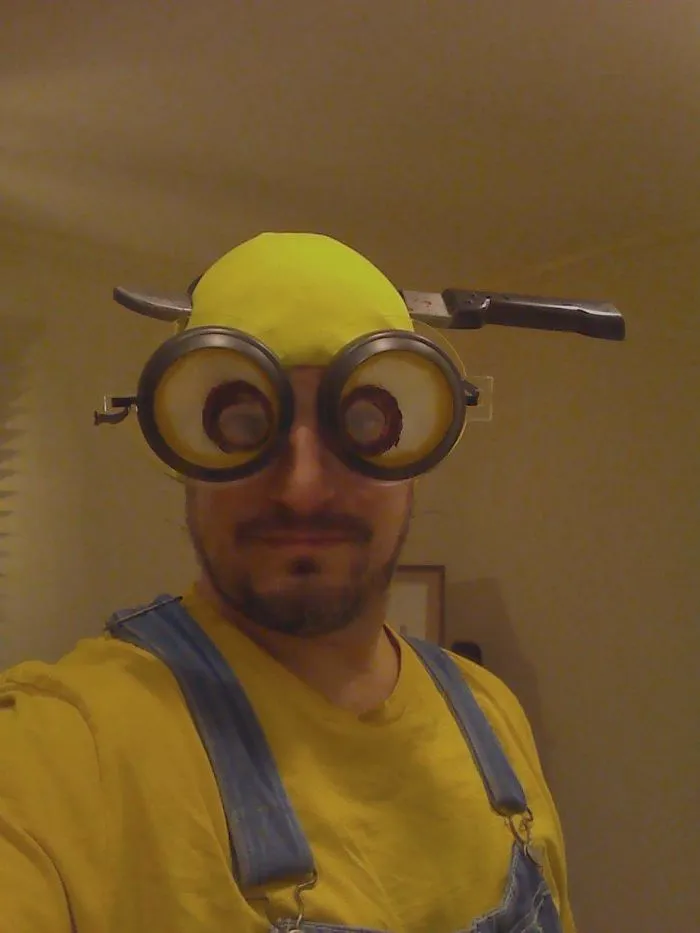Man wearing yellow cap, goggles, and overalls showing creative Halloween costume ideas