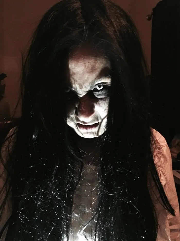 A spooky character with dark hair and white contact lenses as creative Halloween costume ideas
