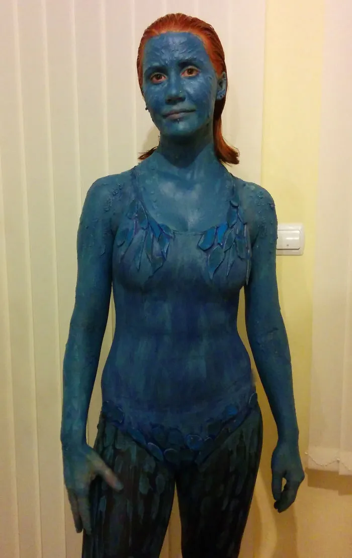 Woman in full Mystique blue body paint for creative Halloween costume ideas.