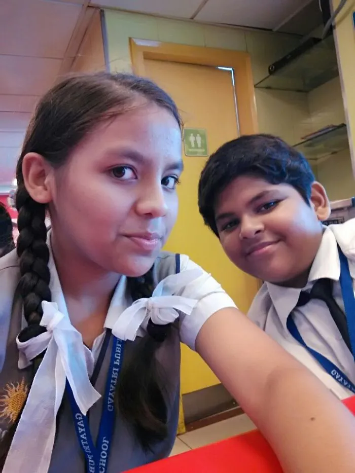Two students taking a selfie together, inspiration for creative Halloween costume ideas.