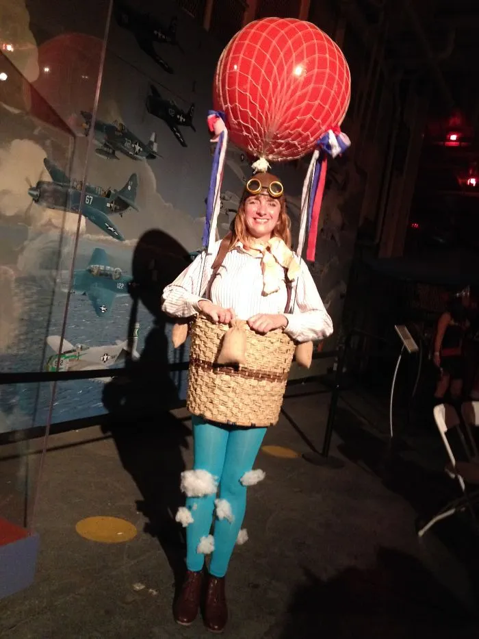 A woman wearing a hot air balloon outfit with aviator goggles, demonstrating creative Halloween costume ideas.