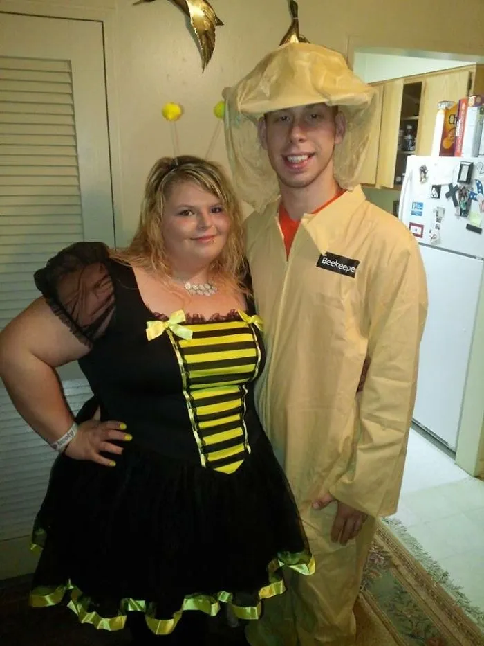 A couple dressed as a bumblebee and beekeeper for creative Halloween costume ideas